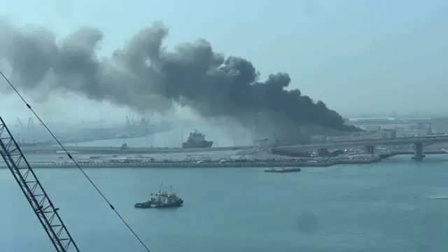 A screengrab from the verified video showing a thick plume of smoke rising from the port near Abu Dhabi