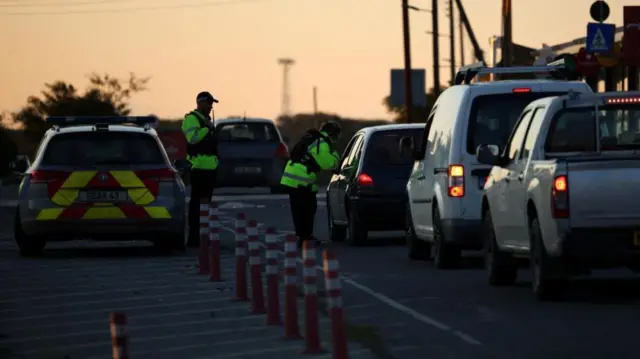 Police check vehicles on the road leading to RAF Akrotiri earlier today