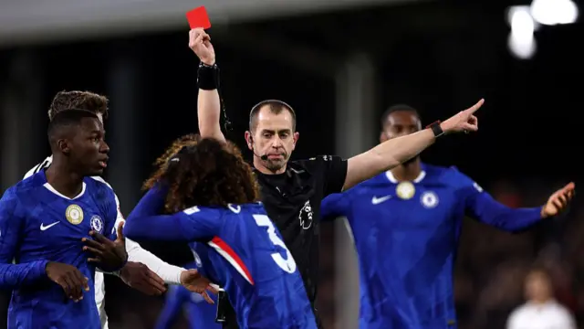 Referee Peter Bankes shows a red card to Marc Cucurella of Chelsea