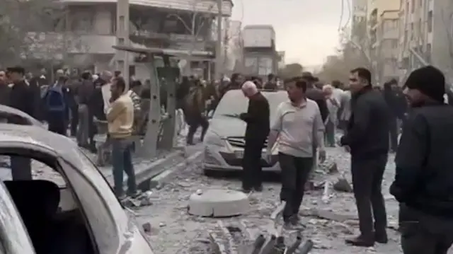 A screengrab from a video showing debris and damaged buildings in west Tehran