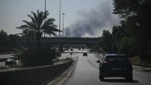 Smoke rising over a road