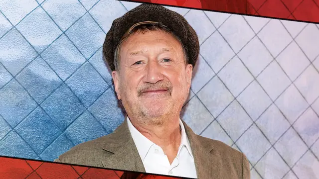 Stephen Knight wears a peaky cap, brown jacket and white shirt