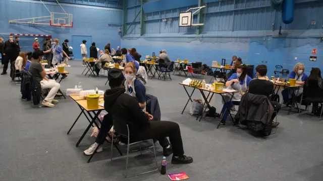 Students receiving vaccines and antibiotics from medical staff in the sports hall at the University of Kent campus in Canterbury