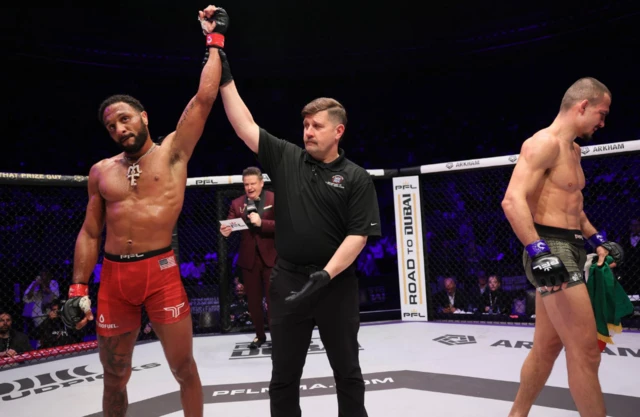 AJ McKee has his hand raised as Adam Borics walks off in disappointed