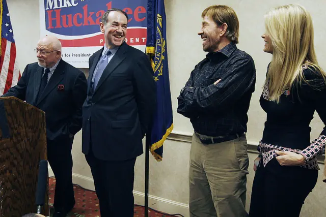 Republican presidential candidate and former Arkansas Governor Mike Huckabee, center, shares a laugh with Actor Chuck Norris, second from right, and his wife Gena,.