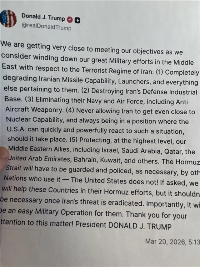 A printed copy of Trump’s latest Truth Social post on “winding down” the US military operations in Iran