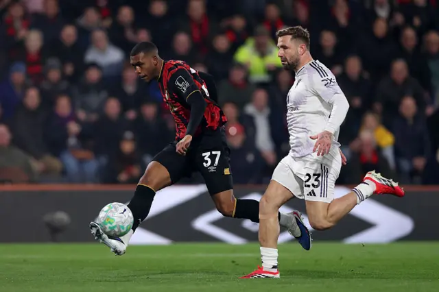 Rayan of AFC Bournemouth shoots whilst under pressure from Luke Shaw of Manchester United