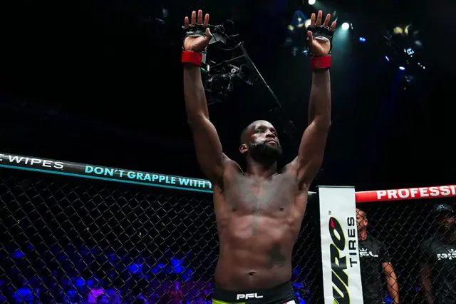 Fabian Edwards in the cage with his hands in the air