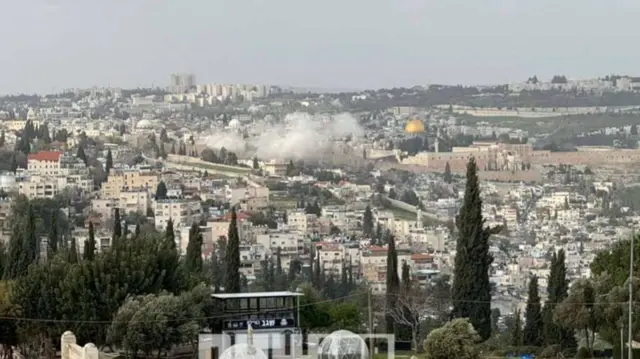 A still image showing smoke rising from the Old City in East Jerusalem following a reported missile debris impact