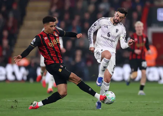 Bruno Fernandes of Manchester United is challenged by James Hill of AFC Bournemouth