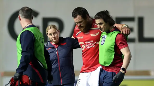 Marnus van der Merwe is helped off the pitch