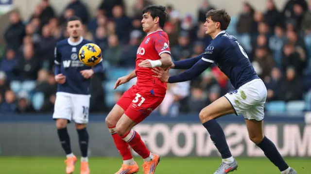 Ipswich's Ivan Azon holds off the challenge of Millwall defender Caleb Taylor