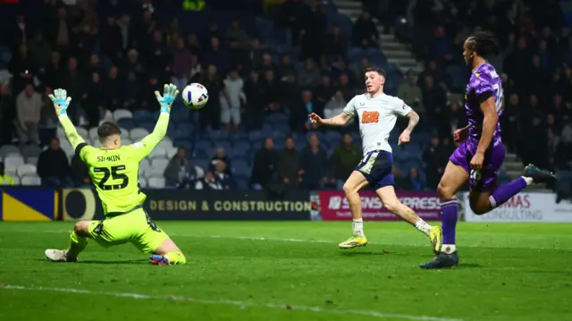 Alfie Devine chips a finish over Stoke goalkeeper Tommy Simkin