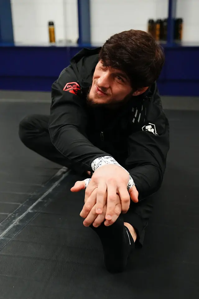 Evloev stretches backstage before a fight