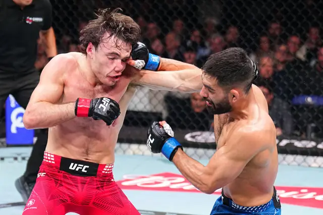 Michael Aswell Jr's thumb hooks the corner of Luke Riley's eye