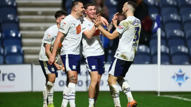 Four Preston players celebrating a goal for Alfie Devine against Stoke