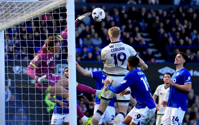 Ipswich Town goalkeeper Christian Walton in action against Josh Coburn of Millwall