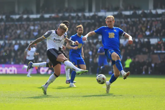 Derby County's Sammie Szmodics (left) takes a shot on goal d