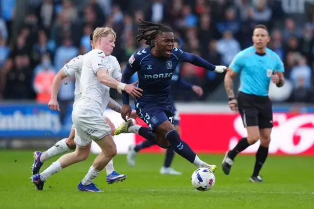 Coventry City's Brandon Thomas-Asante (centre) runs ahead of Swansea City's Melker Widell (left)