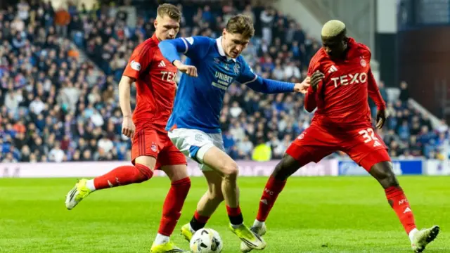 Rangers' Ryan Naderi is closed down by two Aberdeen players