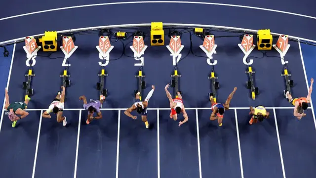 Athletes compete in the men's 60m hurdles semi-finals
