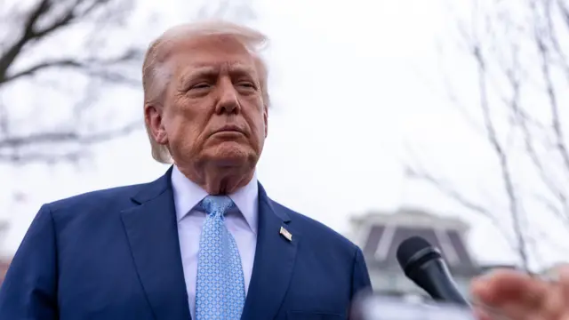 Trump responds to a question from the news media as he walks to board Marine One on the South Lawn of the White House.