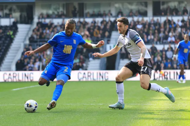 Birmingham City's Ethan Laird and Derby County's Lewis Travis