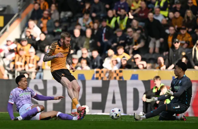 Goalkeeper Pierce Charles of Sheffield Wednesday saves from Oliver McBurnie of Hull City