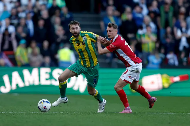 Nat Phillips of West Bromwich Albion holds off Scott Twine of Bristol City