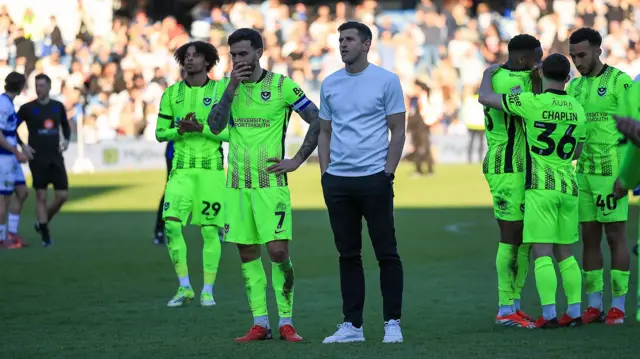 A dejected looking Portsmouth boss John Mousinho and players after a 6-1 loss at QPR