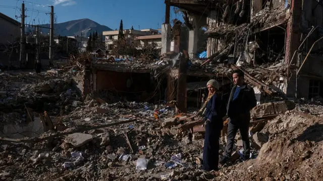 Civilians look upon the remains of a residential and commercial building in the Shahrak-e Gharb neighbourhood of Tehran, Iran.
