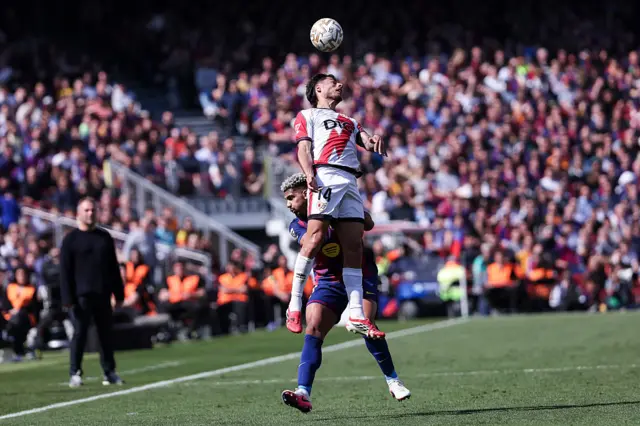 : Carlos Martin of Rayo Vallecano and Ronald Araujo of FC Barcelona compete for the ball