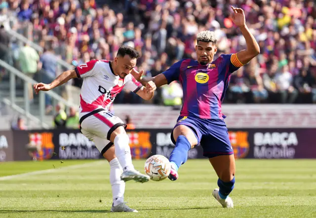 Alvaro Garcia of Rayo Vallecano is challenged by Ronald Araujo of FC Barcelona