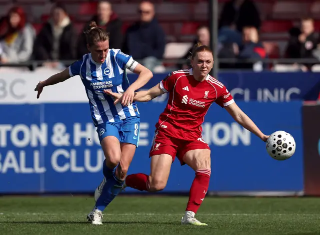 Symonds and Holland battle for the ball