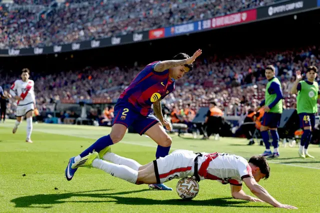 Barcelona's Portuguese defender #02 Joao Cancelo fights for the ball with Rayo Vallecano's Romanian defender #02 Andrei Ratiu (