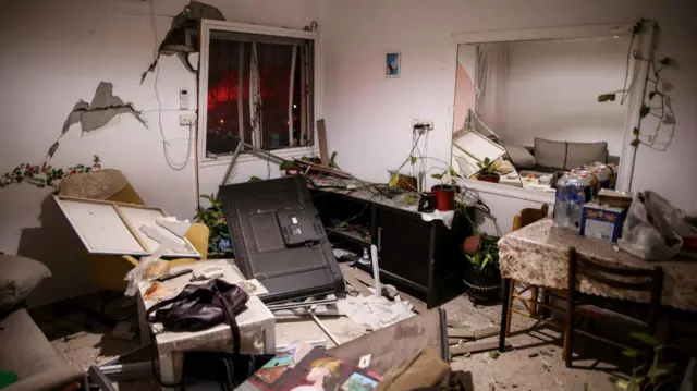A damaged room at an impact site after Iranian missile barrages struck residential buildings in Arad.