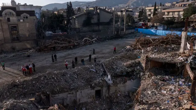 Civilians look upon the remains of a residential and commercial building in the Shahrak-e Gharb neighbourhood of Tehran, Iran.