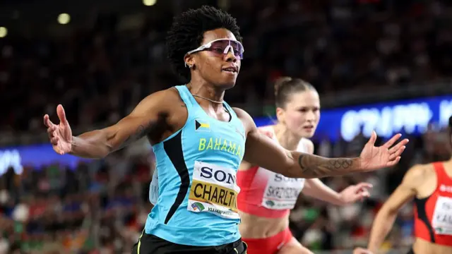 Devynne Charlton of Team Bahamas crosses the finish line
