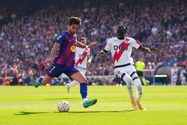 Ferran Torres of FC Barcelona passes the ball under pressure from Pathe Ciss of Rayo Vallecano
