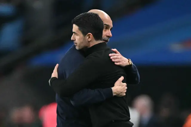 Pep Guardiola and Mikel Arteta embracing after the game