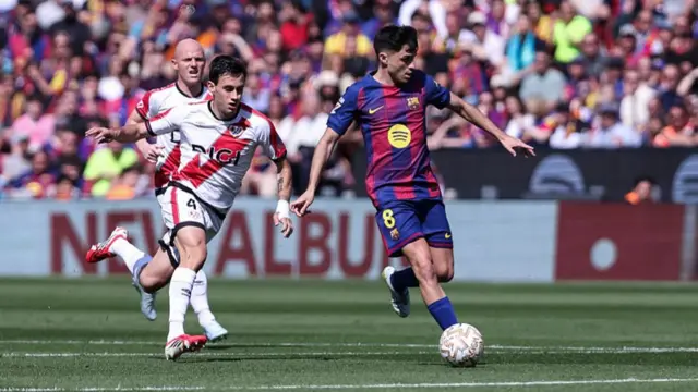 Pedri of FC Barcelona and Pedro Diaz of Rayo Vallecano in action