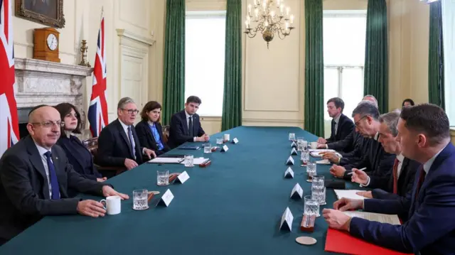 Starmer sits at a table as he speaks to Jewish community leaders