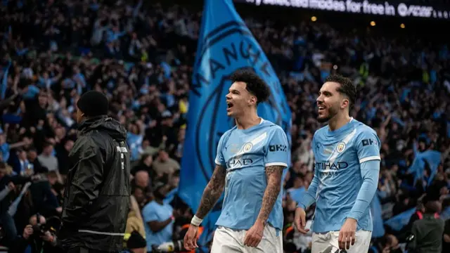 Nico O'Reilly and Rayan Cherki look towards the Manchester City fans