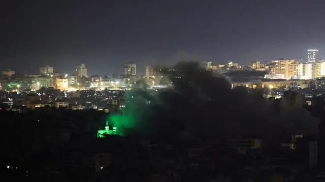 Smoke rises over buildings in Beirut's southern suburbs