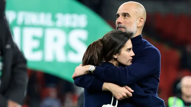 Pep Guardiola hugs his daughter Maria on the Wembley pitch