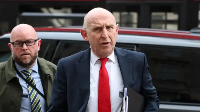 British Defence Secretary John Healey walks outside the Cabinet Office, on the day Prime Minister Keir Starmer holds an emergency "COBRA" meeting on the economic fallout amid the U.S.-Israeli conflict with Iran, in London, Britain, March 23, 2026.