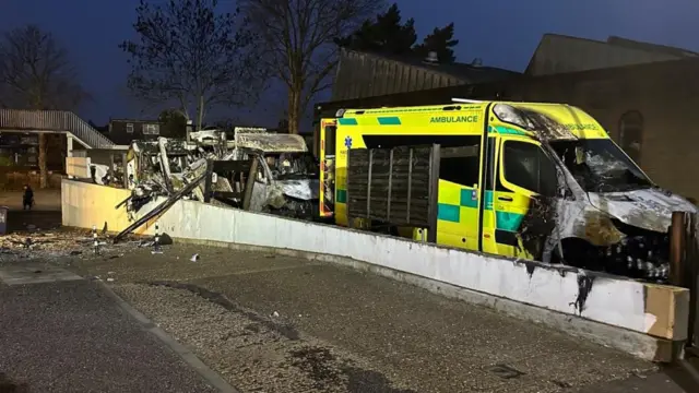 Ambulances shown with extensive fire damage on Highfield Road, Golders Green, London, after an apparent arson attack.