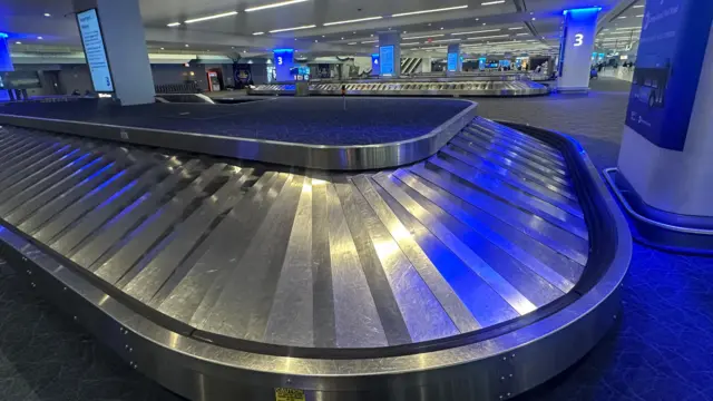 An empty baggage carousel at an airport