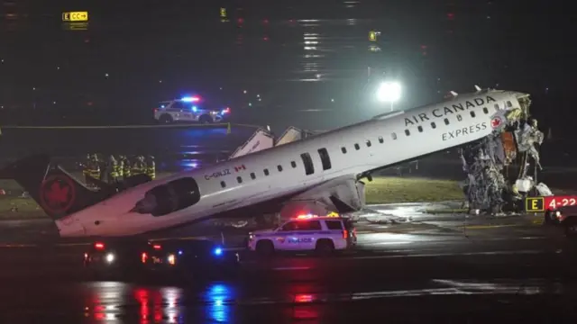 An Air Canada aircraft is shown on the tarmac, with its destroyed nose pointing upwards.