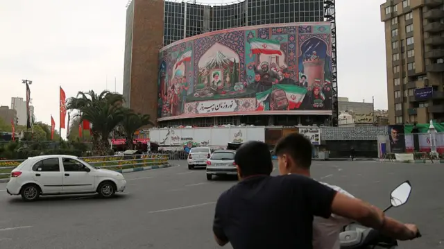 A general view of the large banners placed in the city center, which also feature a portrait of Iranian leader Ayatollah Ali Khamenei, who was killed in the attacks, as daily life continues, twenty three days after the US and Israeli attacks on Iran began on February 28, in Tehran, Iran on March 22, 2026.
